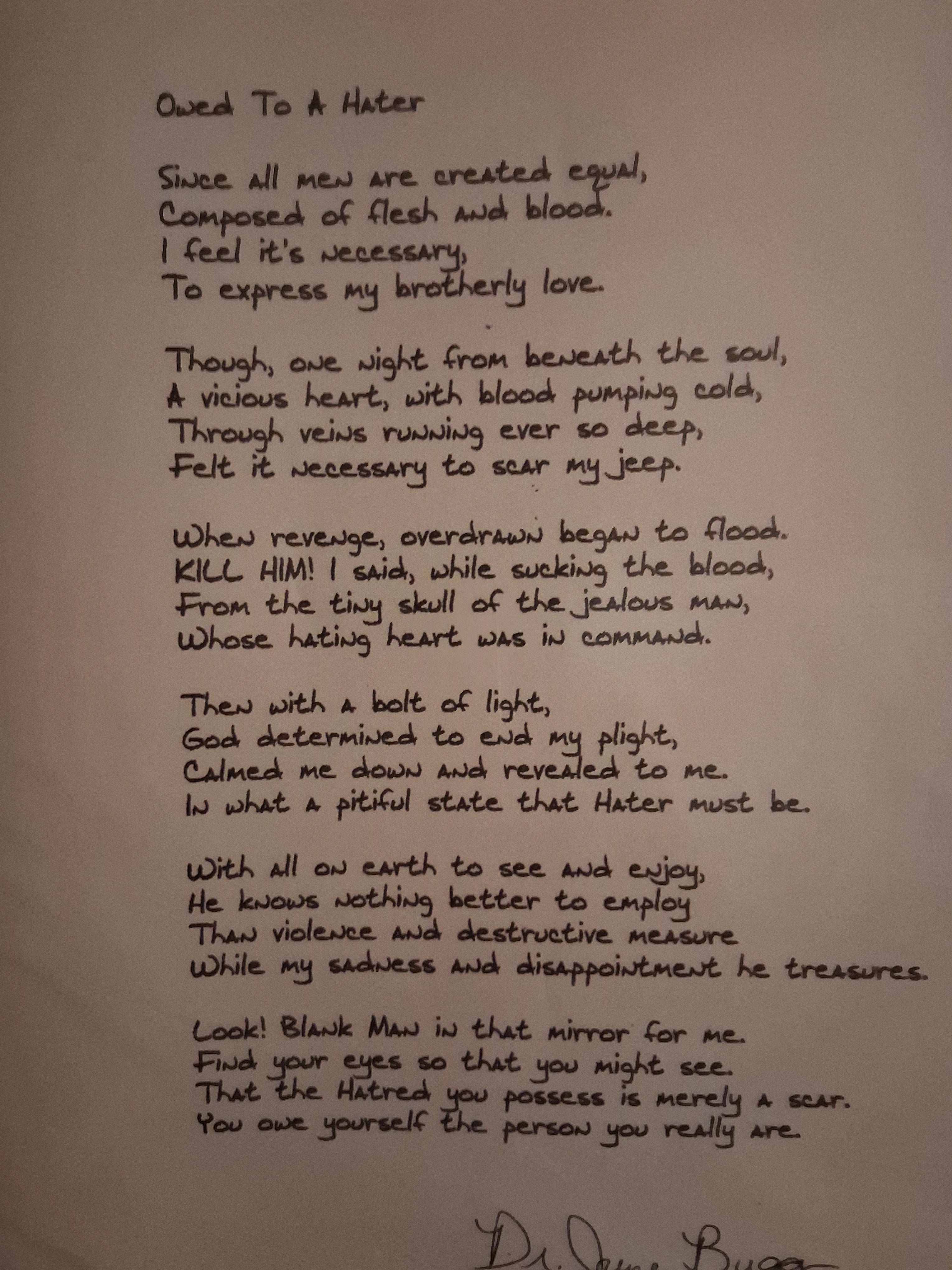 A handwritten poem printed on a plain light background, with the title, ''Owed To A Hater'' at the top and a cursive signature at the bottom. The author, Eddie Wyatt Jr, has signed in his alias name, ''Dr. JuneBugg.''